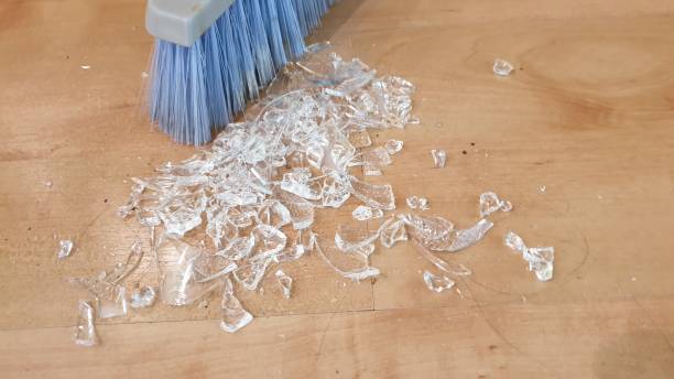 istock Brush sweeping up broken glass on wooden floor 1136563670