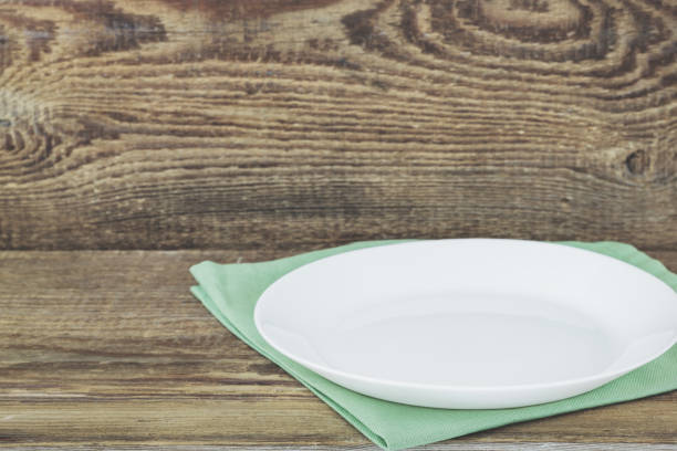 istock Empty plate on tablecloth on wooden table over grunge background 1136563913