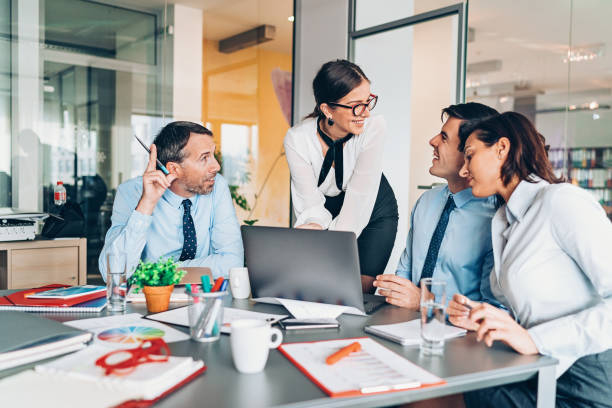 istock Group of businesspersons talking in the office 1136564620