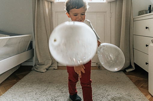 Boy having fun with balloons