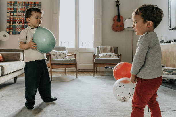istock Boys having fun with balloons 1136568828