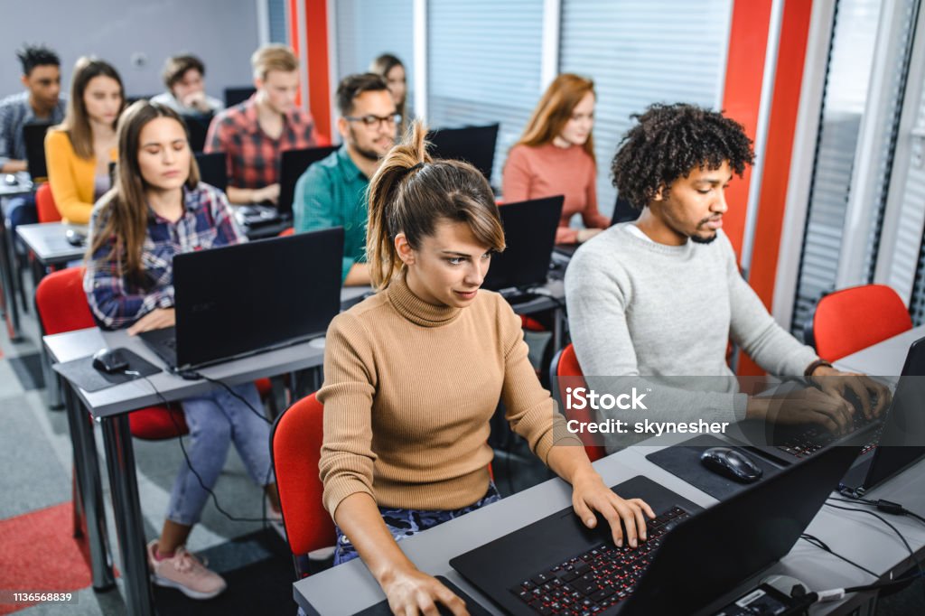 Large Group Of Students Using Laptops On A Class At Computer Lab Stock ...