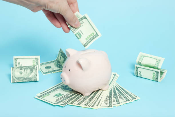 istock Piggy bank money on blue background 1136570633