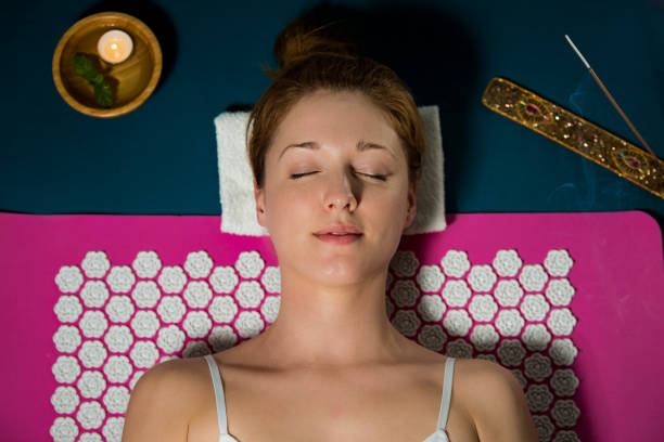 istock Woman with closed eyes Relaxing at home 1136573487