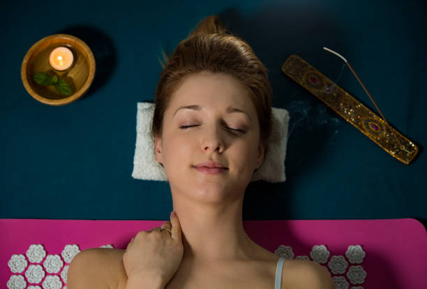 istock Woman with closed eyes Relaxing at home 1136573488