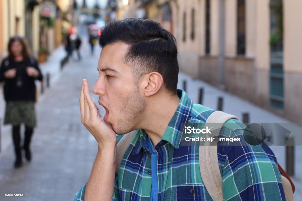 Man checking his own breath Man checking his own breath. Bad Breath Stock Photo