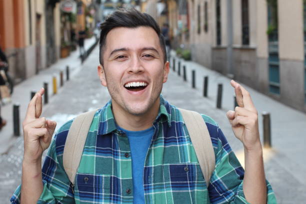 istock Man with fingers crossed outdoors 1136574541