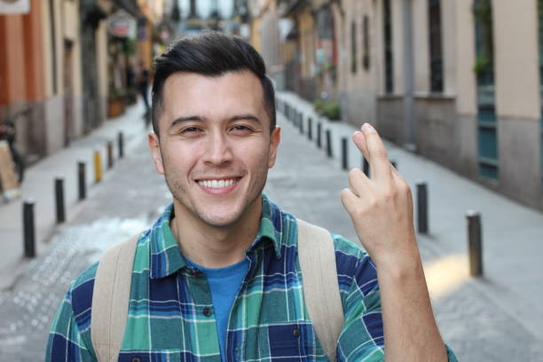istock Man with fingers crossed outdoors 1136574590