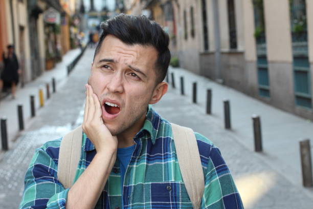 istock Guy experimenting intense toothache outdoors 1136574674