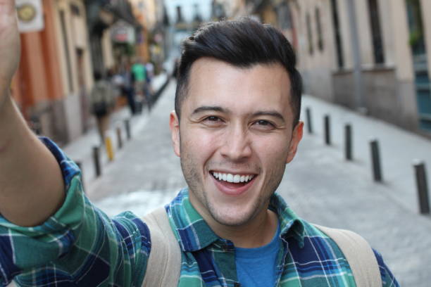 istock Cute man taking a selfie outdoors 1136574735