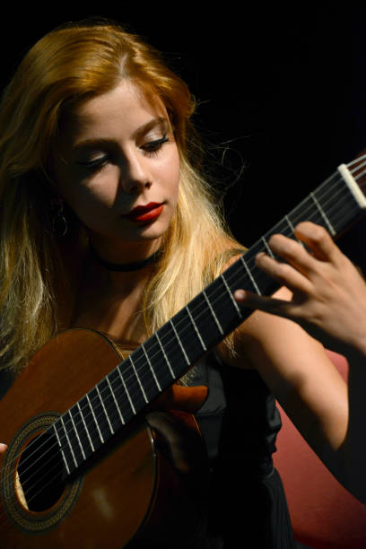istock Woman playing guitar 1136578409