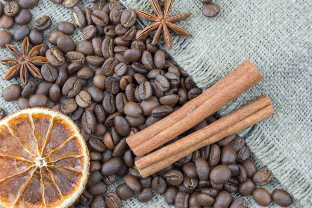 istock Coffee beans, cinnamon sticks scattered on the burlap. 1136582518