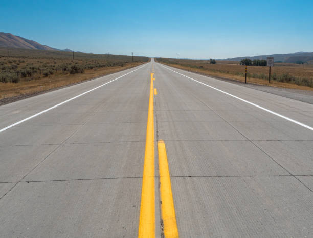 Lonely straight road in Utah, USA Lonely straight road in Utah, USA single yellow line sunlight usa utah stock pictures, royalty-free photos & images