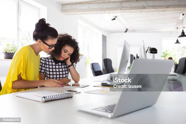 Creative Women Working Together Stock Photo - Download Image Now - 20-24 Years, Adult, Adults Only
