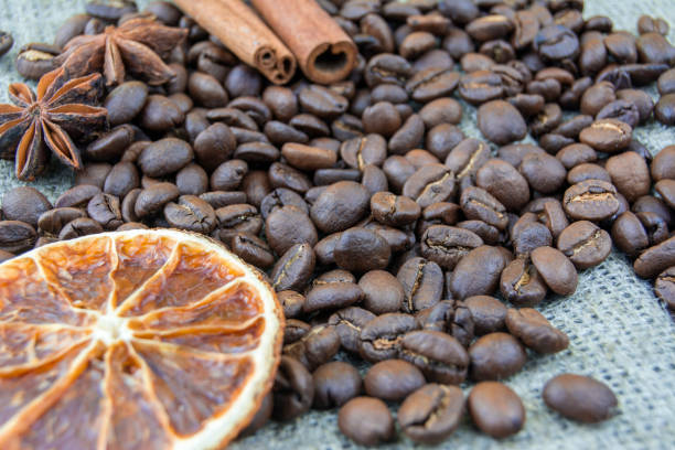 Coffee beans, cinnamon sticks scattered on the burlap.