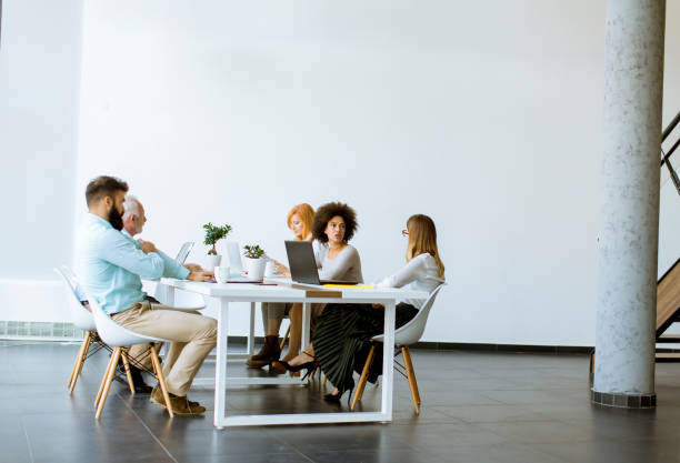 istock Joyful multiracial business team at work in modern office 1136586022