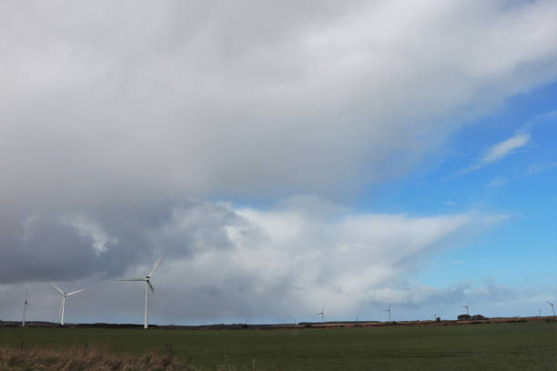 istock Wind turbines on hilltop under overcast sky 1136587028