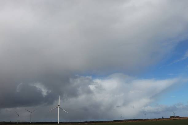 istock Wind turbines on hilltop under overcast sky 1136587043