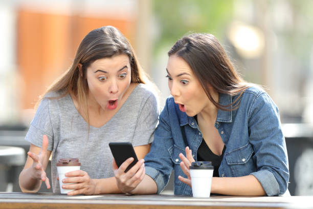 istock Surprised friends finding amazing phone online content 1136589992