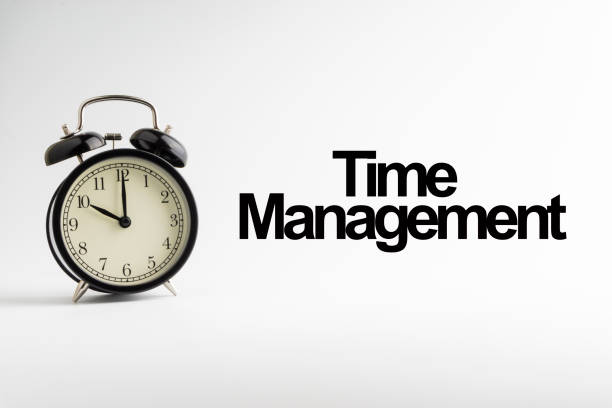 istock TIME MANAGEMENT inscription written and alarm clock on white background. 1136590076