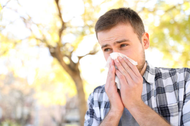 istock Ill or allergic man coughing in a park 1136590519