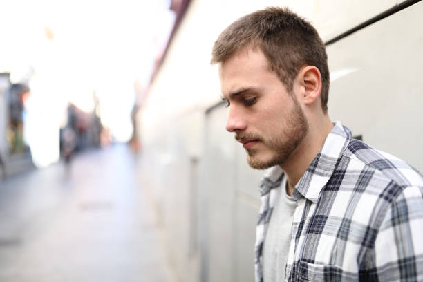 Sad man complaining alone in the street