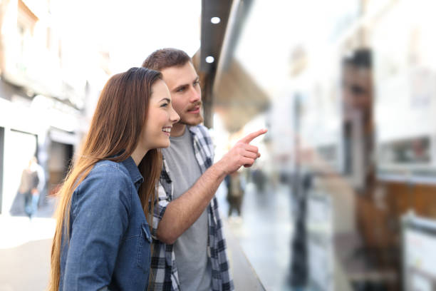 Couple checking storefront in the street