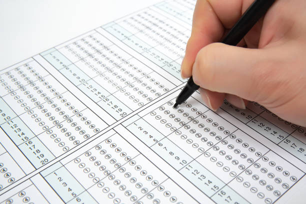 man is filling omr sheet handing with pen. - close up medical test exam people imagens e fotografias de stock