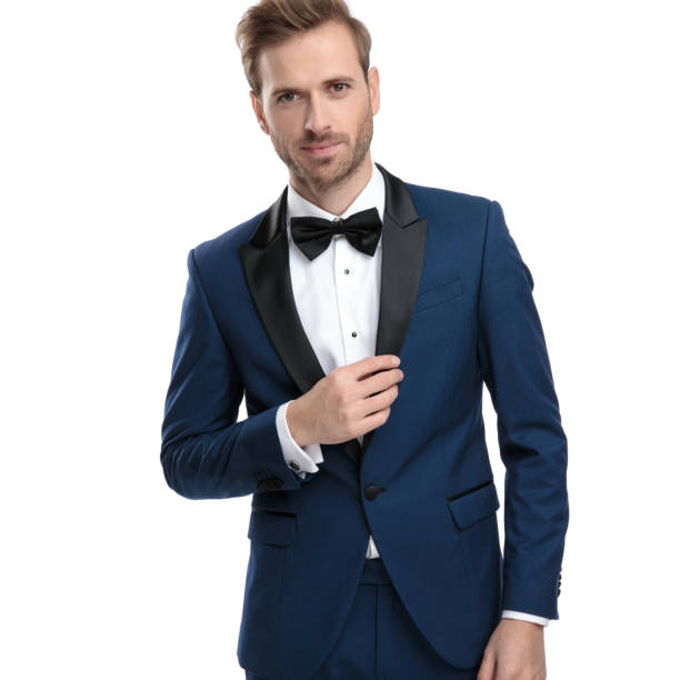 istock luxury man in blue tuxedo adjusting his lounge jacket collar 1136593649