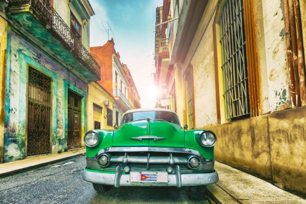 Vintage green oldtimer car driving through Old Havana Cuba Vintage oldtimer car driving through Old Havana Cuba havana photos stock pictures, royalty-free photos & images