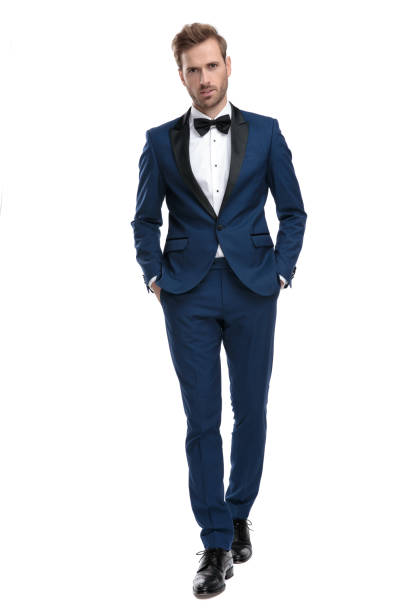handsome guy stepping with hands in pockets handsome guy in blue suit stepping with hands in pockets on white background black men with blonde hair stock pictures, royalty-free photos & images