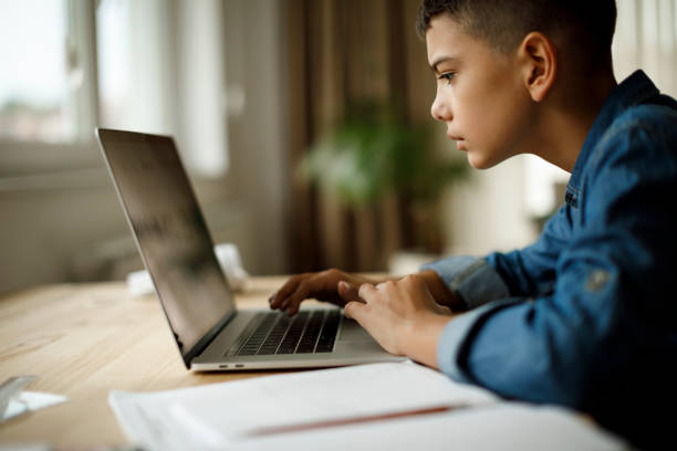 istock Teenage boy using laptop for homework 1136594874