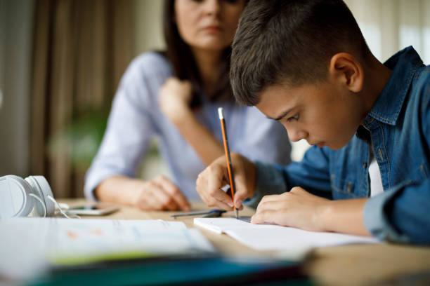 istock Mother helping her son with homework 1136594998