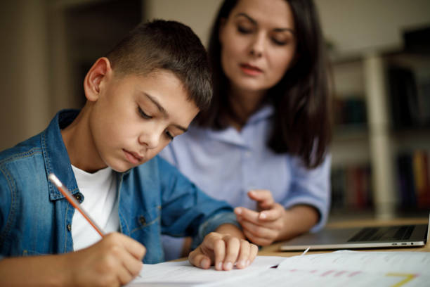 istock Mother helping teenager with homework 1136595049