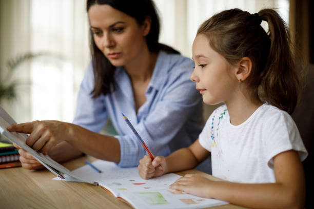 istock Mother helping daughter with homework 1136595083