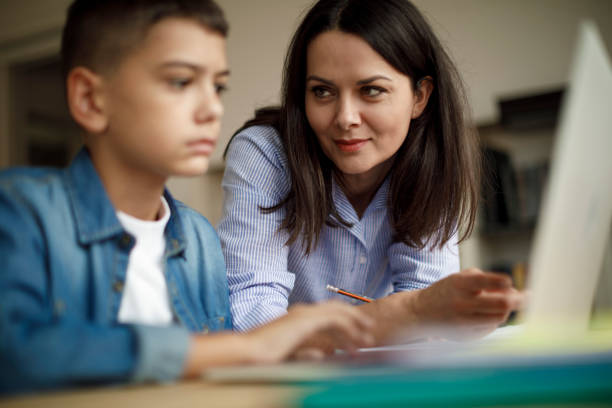 istock Mother an son using laptop at home 1136595105