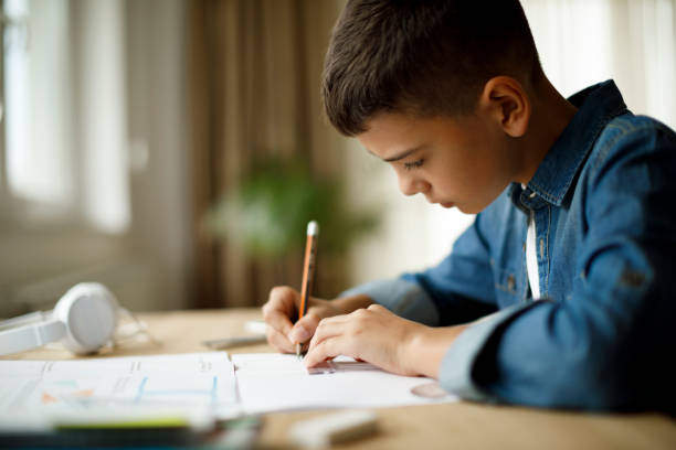 istock Teenage boy doing homework 1136595109