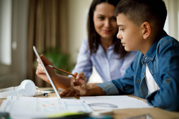 istock Mother helping teenager with homework 1136595239