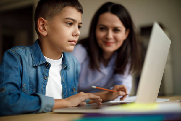 istock Mother an son using laptop at home 1136595276