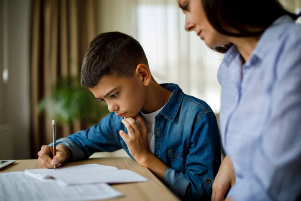 istock Mother helping her son with homework 1136595324