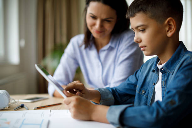 istock Mother helping teenager with homework 1136595334