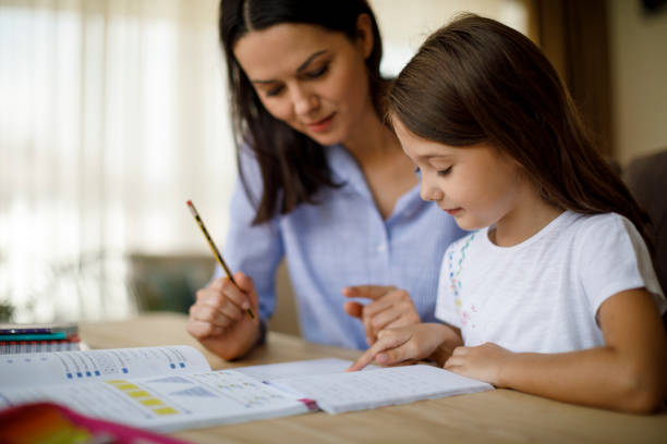 istock Mother helping daughter with homework 1136595354