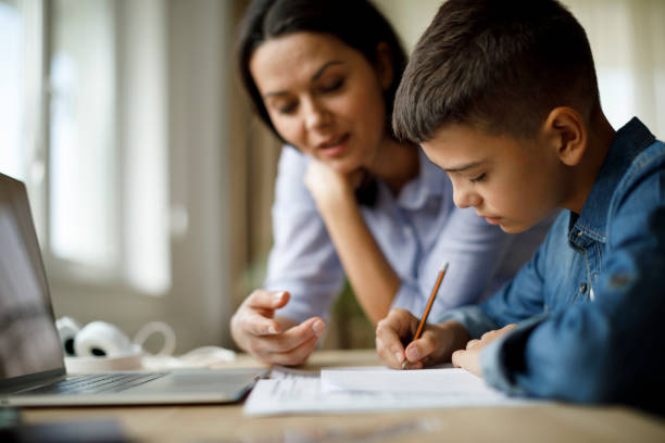 istock Mother helping teenager with homework 1136595382