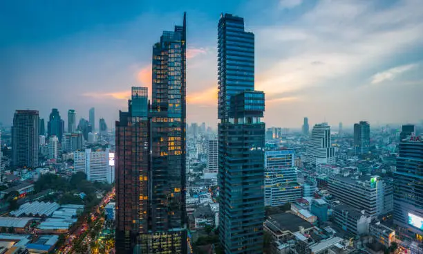 Panoramic aerial view across the futuristic skyscrapers and crowded high rise cityscape of central Bangkok, Thailand’s vibrant capital city.