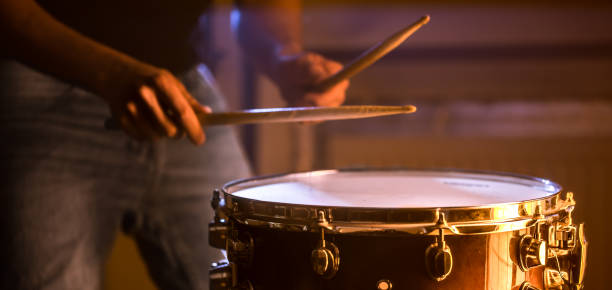 istock man playing the snare drum on a beautiful colored background 1136596655