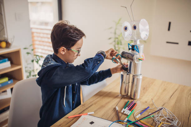 istock Boy making a robot for school science project at home 1136597149