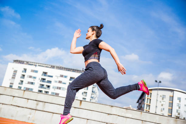 istock Woman jumping and running 1136597380