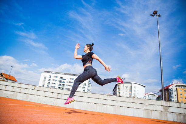 istock Woman jumping and running 1136597544