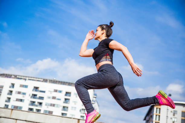 istock Woman jumping and running 1136597562
