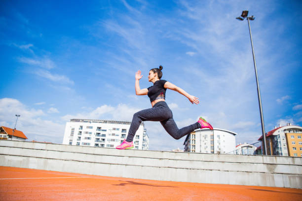 istock Woman jumping and running 1136598034